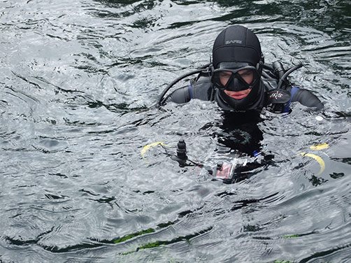 Diver at the surface with an underwater camera