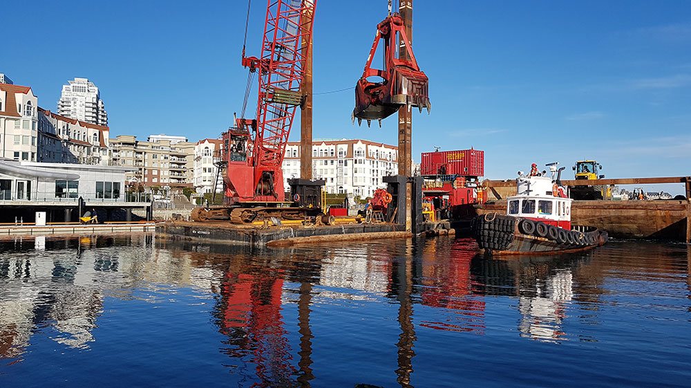 Piling barges and cranes at Victoria International Marina during construction