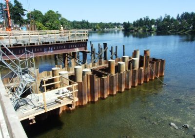 Pile wall and new dock under construction on calm water